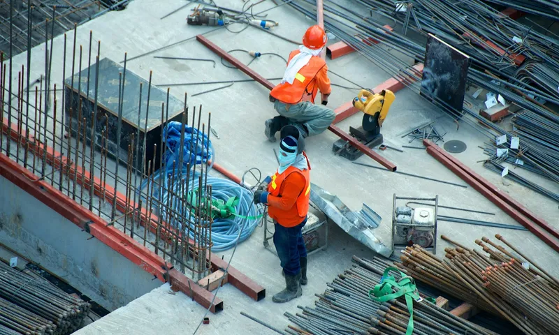 Crew placing rebar on a concrete construction deck