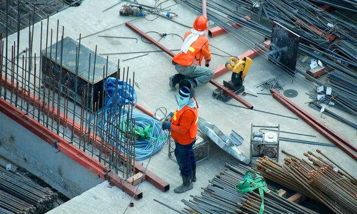 Crew placing rebar on a concrete construction deck