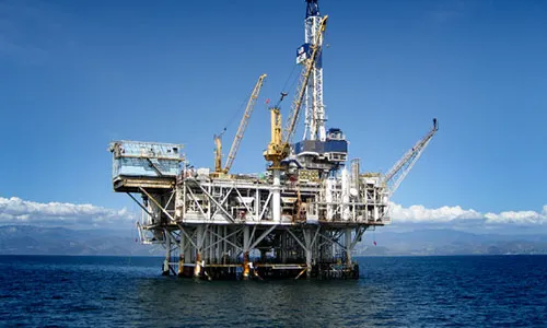 A fixed steel platform standing in open water — marine infrastructure comparable to lock-and-dam gate structures, not a lock itself