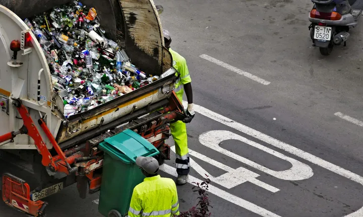Collection truck compacting recycling at the curb